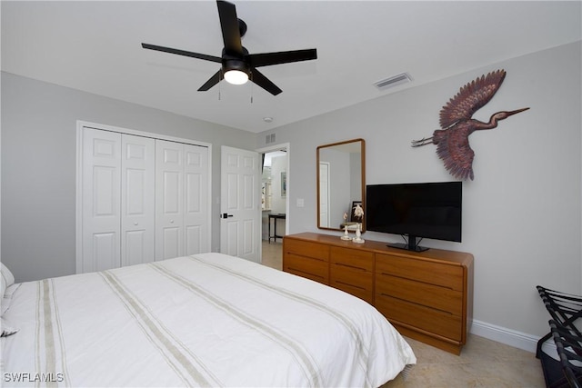 bedroom featuring light tile patterned flooring, visible vents, baseboards, a ceiling fan, and a closet