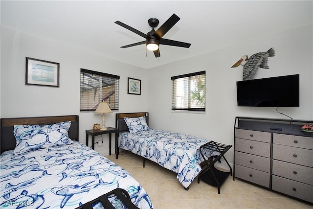 bedroom with ceiling fan and light tile patterned floors