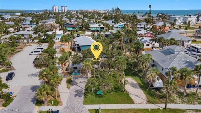 drone / aerial view with a water view and a residential view