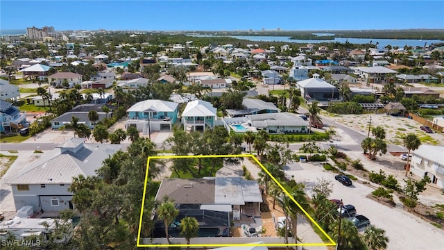 birds eye view of property featuring a water view and a residential view