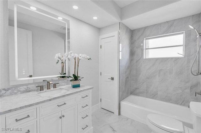 full bathroom featuring vanity, toilet, and tiled shower / bath