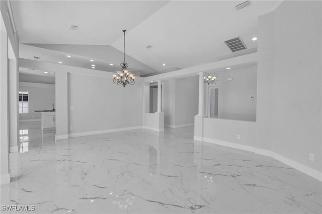 spare room featuring lofted ceiling and a notable chandelier