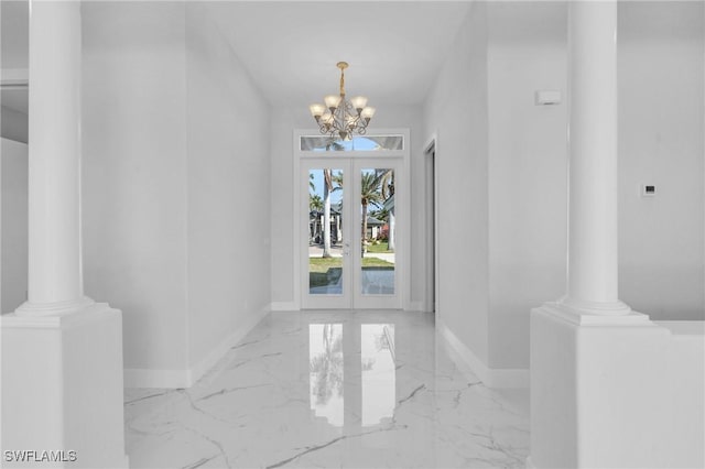 entrance foyer featuring french doors and a notable chandelier