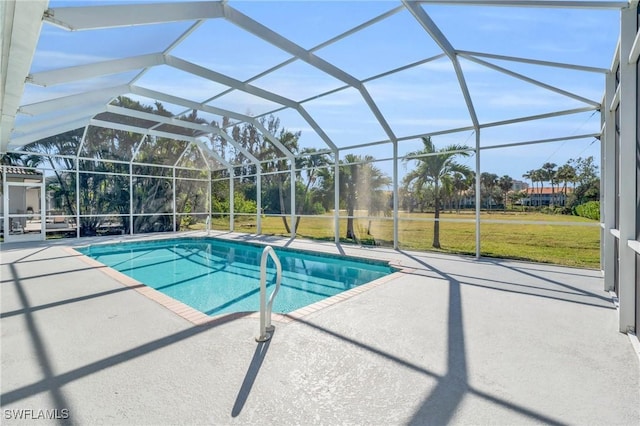 view of swimming pool with a lawn, glass enclosure, and a patio area