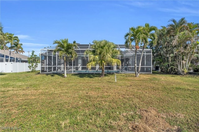 view of yard with glass enclosure