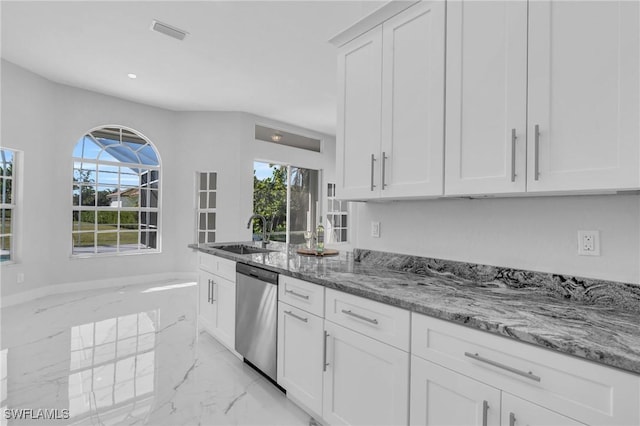 kitchen featuring dishwasher, white cabinetry, plenty of natural light, and sink