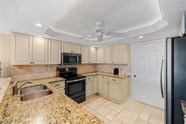 kitchen with backsplash, stainless steel appliances, a tray ceiling, and sink