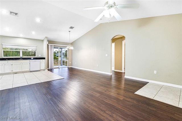 unfurnished living room with light wood-type flooring, ceiling fan, lofted ceiling, and sink