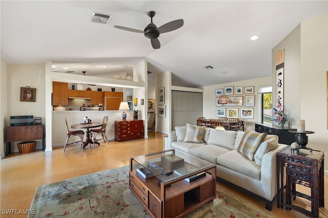 living room with ceiling fan and vaulted ceiling