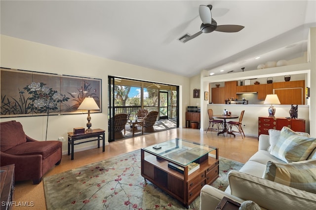 living room with ceiling fan and vaulted ceiling