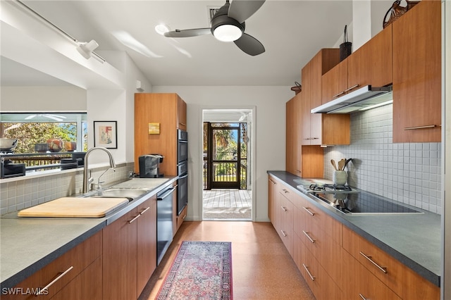 kitchen with plenty of natural light, stovetop, decorative backsplash, and sink