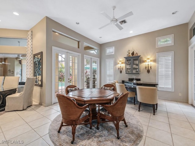 dining area featuring light tile patterned flooring, ceiling fan, and french doors