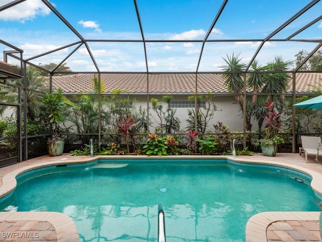 view of swimming pool with a lanai