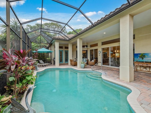 view of swimming pool with a patio and glass enclosure