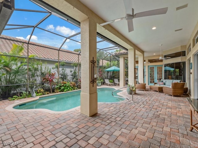 view of swimming pool with an outdoor living space, a patio, ceiling fan, and french doors