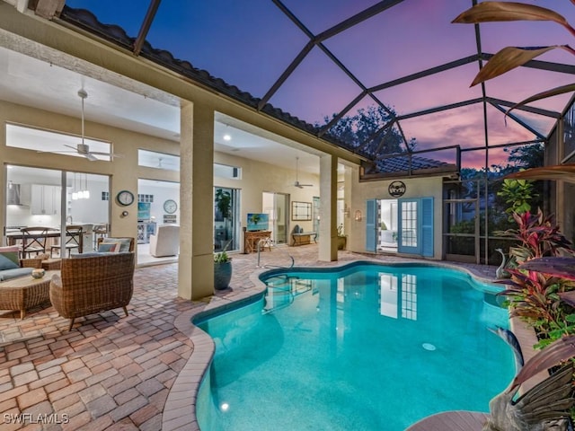 view of pool with a lanai, a patio, and ceiling fan