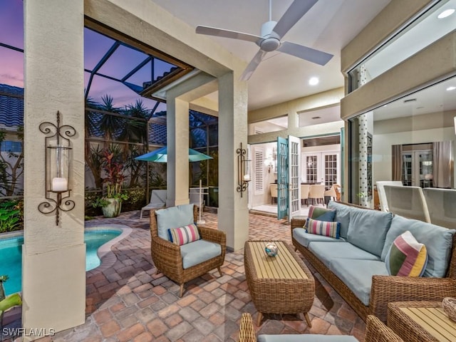 patio terrace at dusk with outdoor lounge area, ceiling fan, and french doors