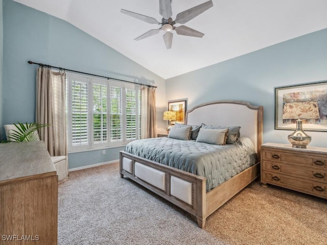 carpeted bedroom with ceiling fan and vaulted ceiling