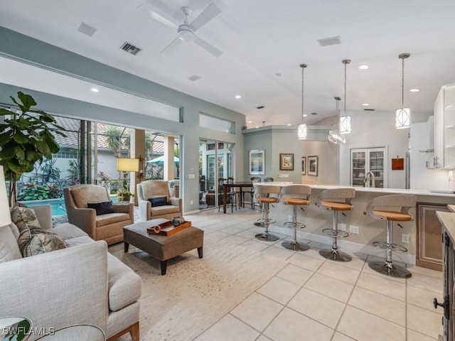 living room with light tile patterned floors and ceiling fan