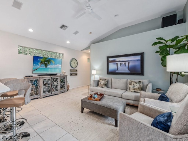 tiled living room with ceiling fan and vaulted ceiling