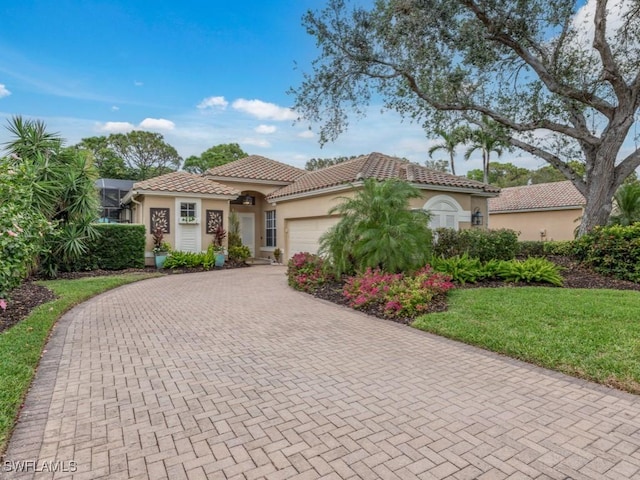 mediterranean / spanish-style home with a garage and a front yard