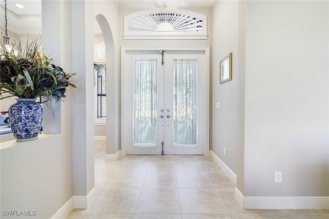 tiled foyer featuring french doors