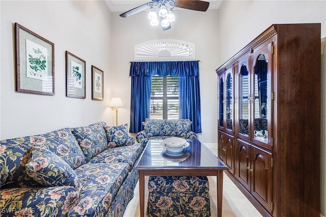 living room with ceiling fan and a towering ceiling