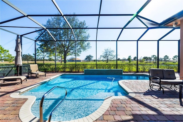 view of swimming pool with a patio area and a lanai