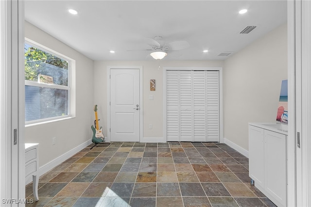 interior space featuring ceiling fan