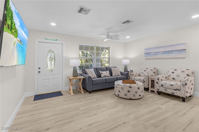 living room with ceiling fan and light wood-type flooring