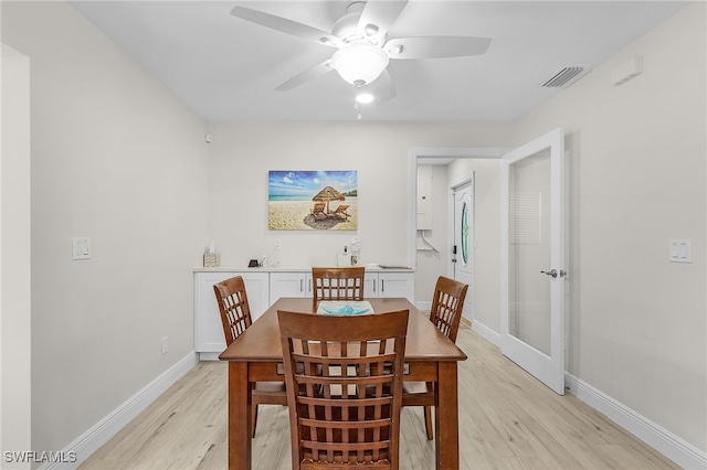 dining room with ceiling fan and light wood-type flooring