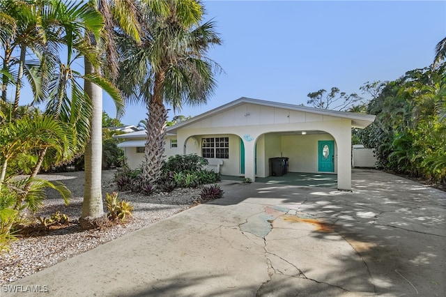 view of front of property featuring a carport