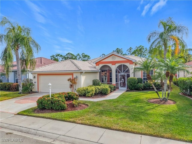 mediterranean / spanish home with a garage and a front yard