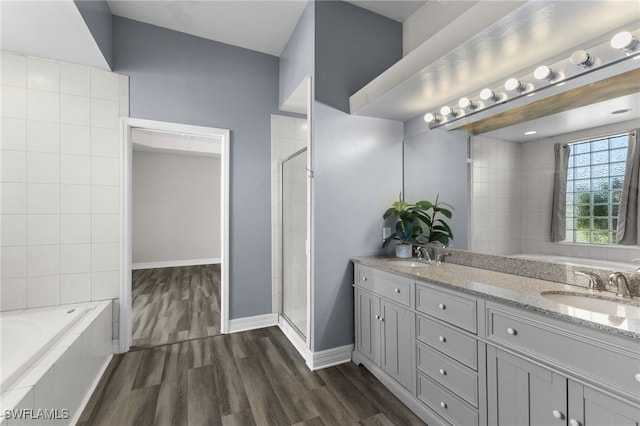 bathroom with hardwood / wood-style flooring, vanity, and independent shower and bath