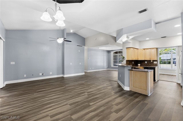 kitchen with decorative backsplash, light brown cabinets, dark wood-type flooring, and vaulted ceiling