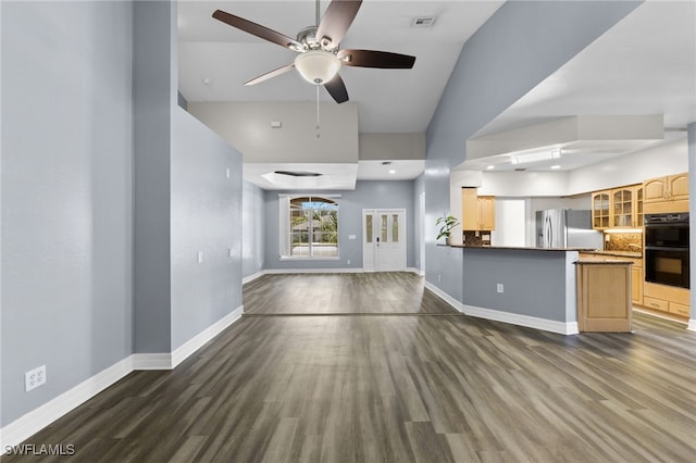 unfurnished living room featuring ceiling fan, dark hardwood / wood-style floors, and high vaulted ceiling