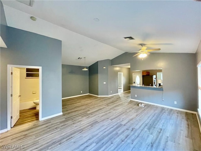 unfurnished room featuring ceiling fan, light wood-type flooring, and lofted ceiling