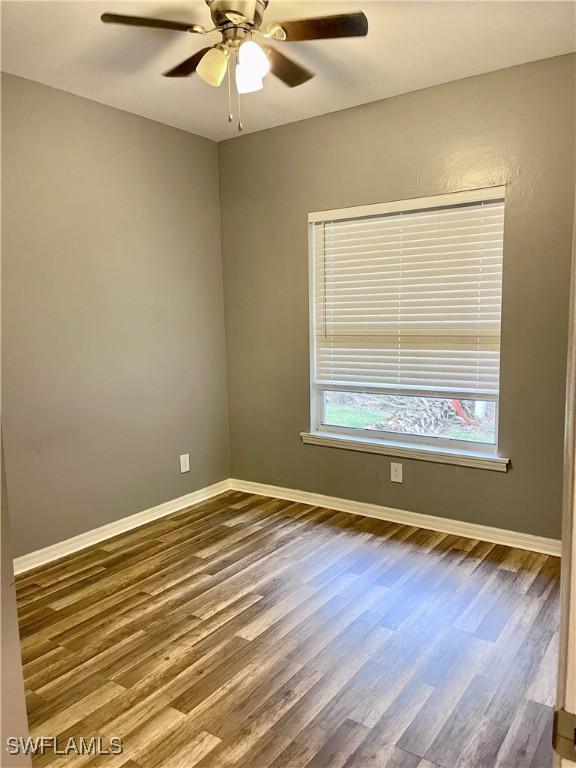 unfurnished room featuring hardwood / wood-style flooring and ceiling fan