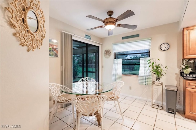 dining area with light tile patterned floors and ceiling fan