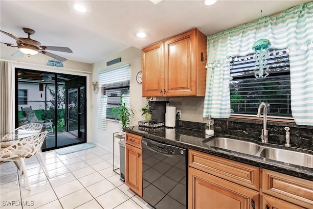 kitchen featuring backsplash, dark stone counters, sink, dishwasher, and light tile patterned flooring