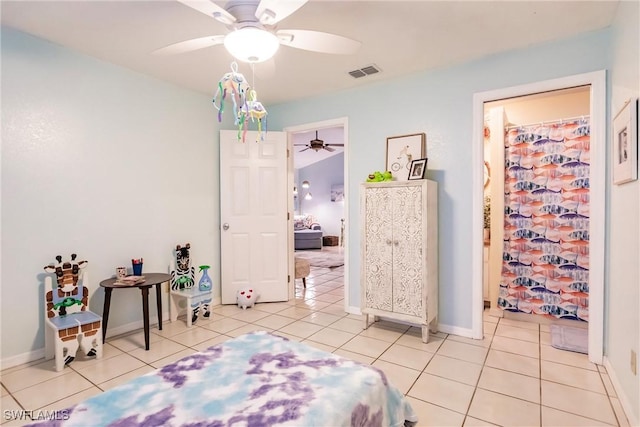 bedroom with ceiling fan and light tile patterned floors