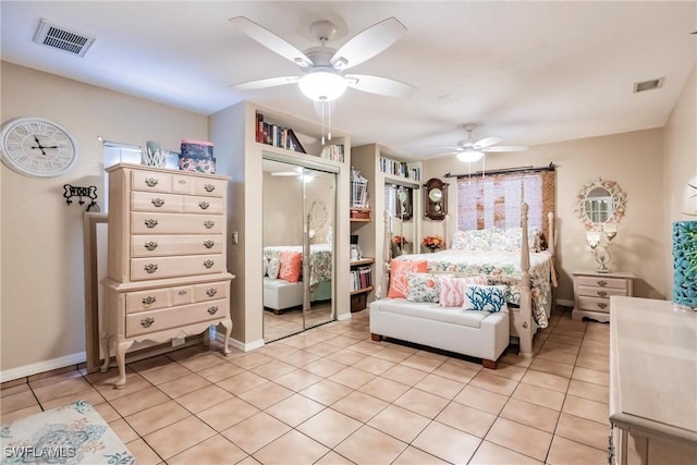 tiled bedroom with a closet and ceiling fan