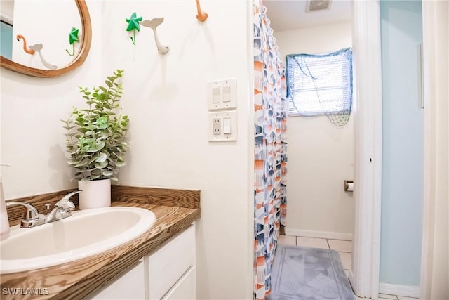 bathroom with tile patterned floors and vanity