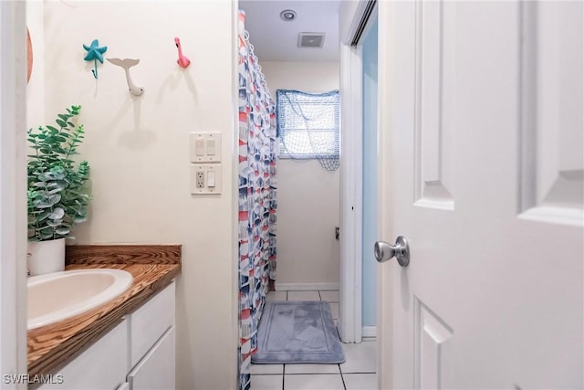 bathroom with tile patterned flooring and vanity