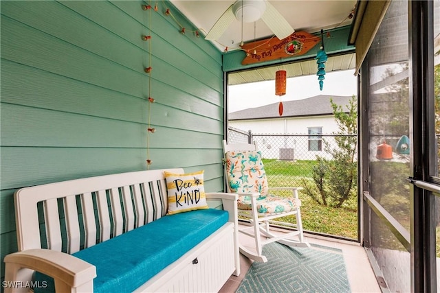 sunroom / solarium featuring ceiling fan