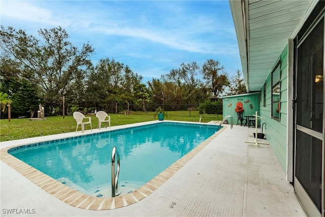 view of pool with a yard and a patio area