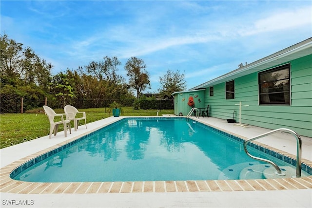 view of pool featuring a lawn and a patio area