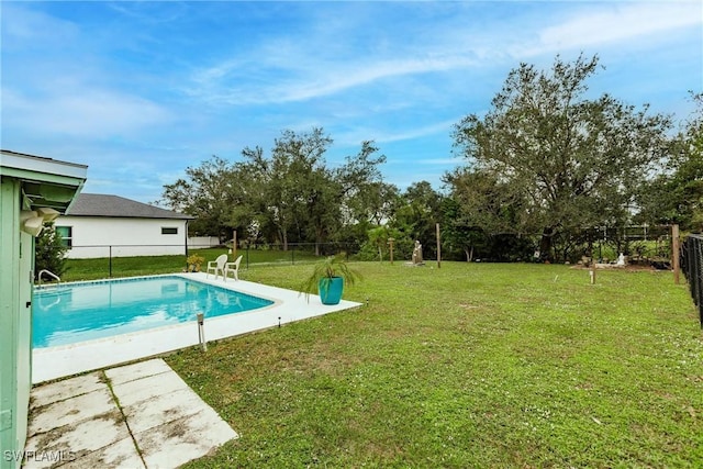 view of pool with a yard