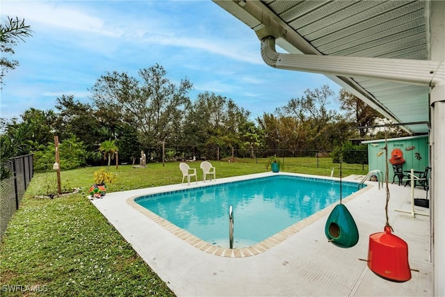 view of swimming pool with a yard and a patio area