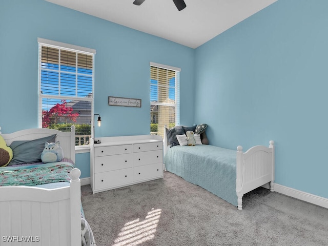 bedroom featuring baseboards, a ceiling fan, and light colored carpet